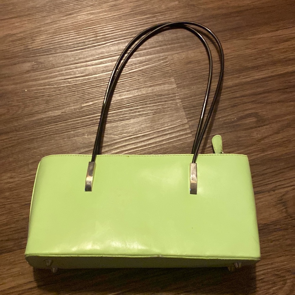 cute green purse with silver detail and black straps